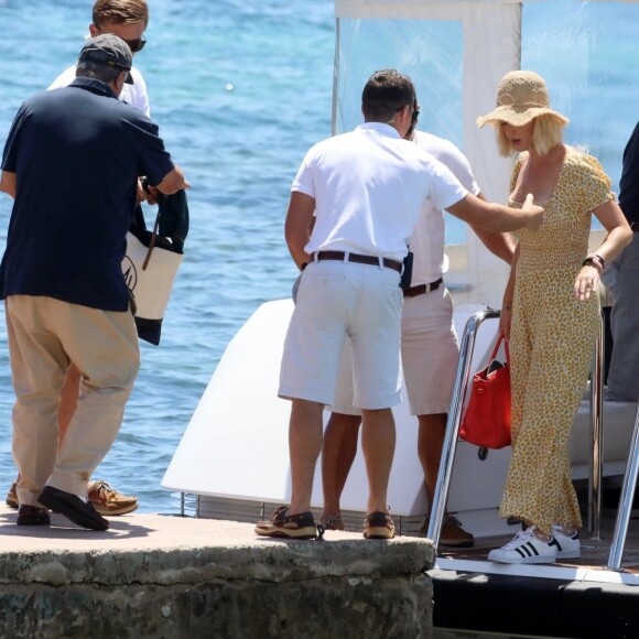 Katy Perry porte une combinaison pantalon fleurie et un chapeau de paille à son arrivée en bateau à Ibiza, le 28 juillet 2019.