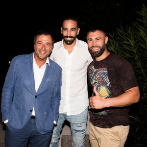 Bernard Montiel, Adil Rami et Yohan Lidon (kickboxeur) assistent à la soirée des 50 ans de l'hôtel le Mas de Bellevue à Saint-Tropez, Côte d'Azur, France, le 8 août 2019. © Jack Tribeca/Bestimage