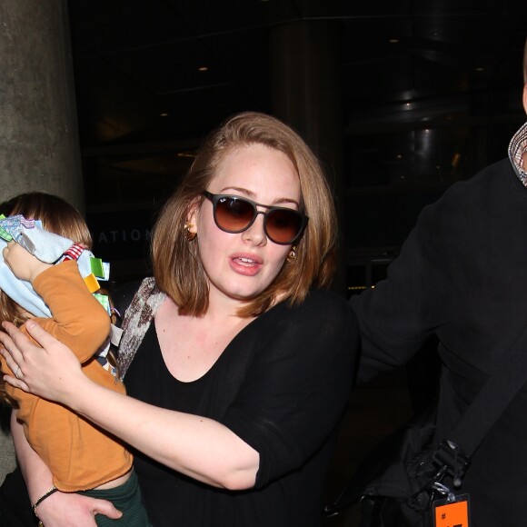 La chanteuse Adele et son fils Angelo Konecki arrivent à l'aéroport LAX de Los Angeles le 3 janvier 2015 entourés de nombreux photographes. La chanteuse serait selon certaines sources séparée de son mari Simon Konecki.