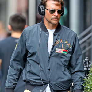 Exclusif - Bradley Cooper se promène à New York. L'acteur âgé de 44 ans était bronzé, portait une longue moustache, un large casque, une veste en nylon Muhammad Ali, un pantalon beige et des baskets grises, le 4 septembre 2019.