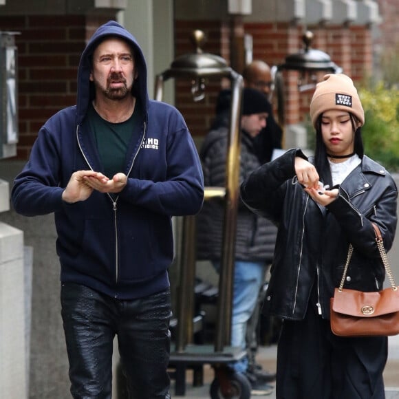 Nicolas Cage et sa compagne Riko Shibata se baladent main dans la main dans le quartier de Manhattan à New York après un diner en amoureux. Le couple s'arrête un moment pour se laver les mains avec un produit hydro-alcooliques. Le 3 mars 2020.