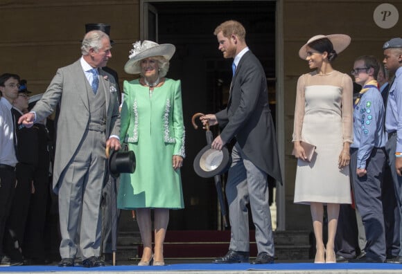 Camilla Parker Bowles, duchesse de Cornouailles, le prince Harry, duc de Sussex, et Meghan Markle, duchesse de Sussex, lors de la garden party pour les 70 ans du prince Charles au palais de Buckingham à Londres en 2018