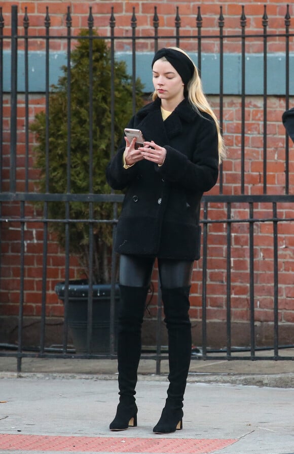 Exclusif - Anya Taylor-Joy au téléphone dans les rues de New York, le 25 février 2020. Elle porte des cuissardes noires.