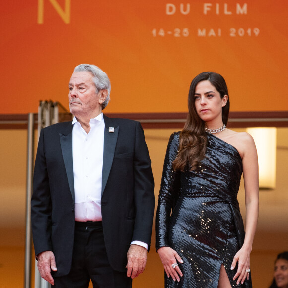 Alain Delon (avec un badge Paris Match d'une ancienne couverture du magazine titrant "Alain Delon, mes deux amours, Rosalie et Anouchka), sa fille Anouchka Delon - Montée des marches du film "A Hidden Life" lors du 72ème Festival International du Film de Cannes. Le 19 mai 2019 © Borde / Bestimage