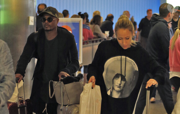 Exclusif - Le footballeur international français qui évolue au poste de défenseur à West Ham United Patrice Evra et son ex femme Sandra arrivent à l'aéroport de LAX à Los Angeles le 21 mai 2018.