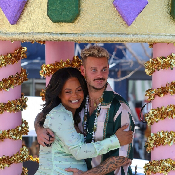 Christina Milian, enceinte, et son compagnon M Pokora (Matt) font la promotion de la marque "Beignet Box" de Christina sur un char lors d'une parade à Los Angeles le 10 avril 2021.