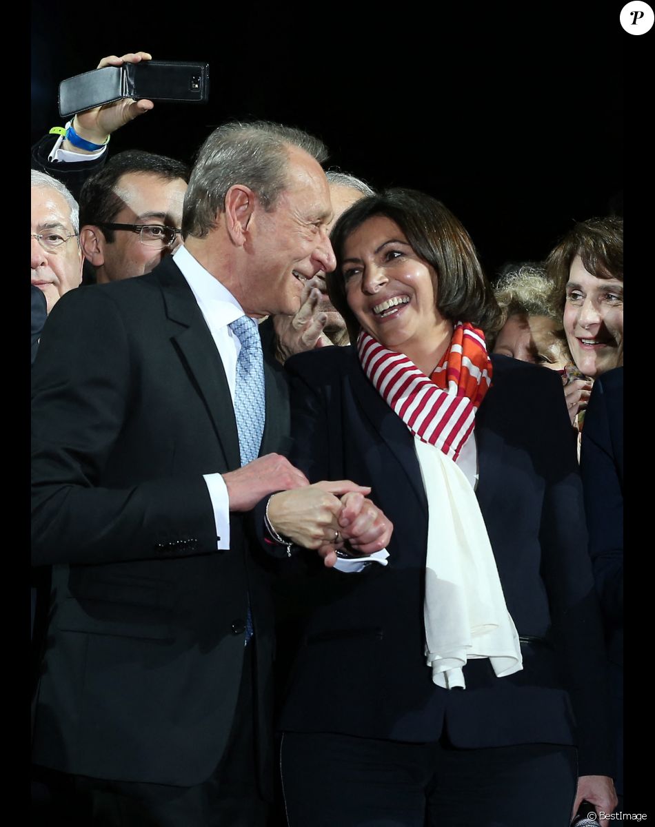 Le maire socialiste sortant Bertrand Delanoë et la nouvelle maire de Paris et la candidate socialiste Anne Hidalgo célèbrent sa victoire lors d'un rassemblement place de l'Hôtel de Ville à Paris, le 30 mars 2014, après l'annonce des résultats du second des élections municipales.