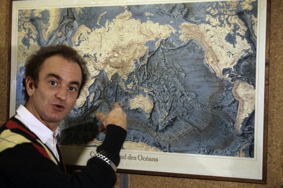 Archives - En France, portrait d'Alain Gillot-Pétré devant une carte du fond des océans.