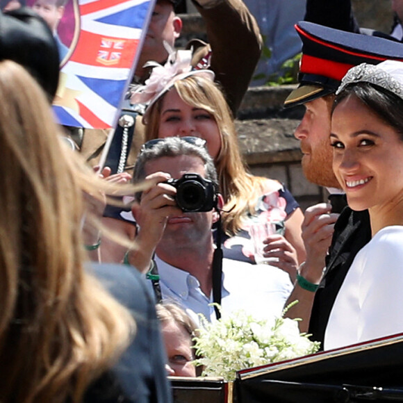 Le prince Harry, duc de Sussex, et Meghan Markle, duchesse de Sussex, en calèche au château de Windsor après la cérémonie de leur mariage au château de Windsor, Royaume Uni, le 19 mai 2018. 