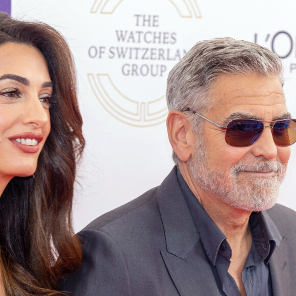 George Clooney et sa femme Amal Clooney arrivent à la soirée "Prince's Trust Awards à Londres, le 15 mai 2023. 