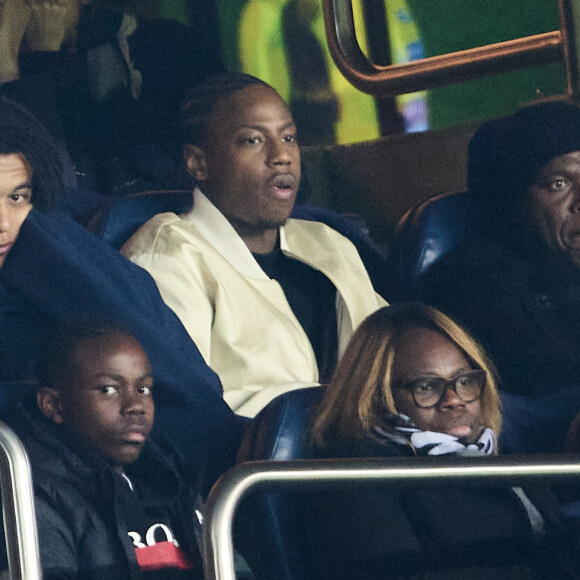 Grand Corps Malade et sa femme Julia Marsaud, Fayza Lamari, Ethan Mbappé, Wilfried Mbappé - People dans les tribunes lors du match de championnat de Ligue 1 Uber Eats opposant le Paris Saint-Germain (PSG) à l'Olympique Lyonnais au Parc des Princes à Paris le 2 avril 2023. 