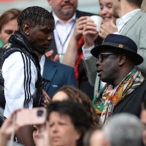 Paul Pogba et Lilian Thuram - Célébrités dans les tribunes du huitième de finale de l'Euro 2024 entre la France et la Belgique (1-0) à Dusseldorf le 1er juillet 2024.