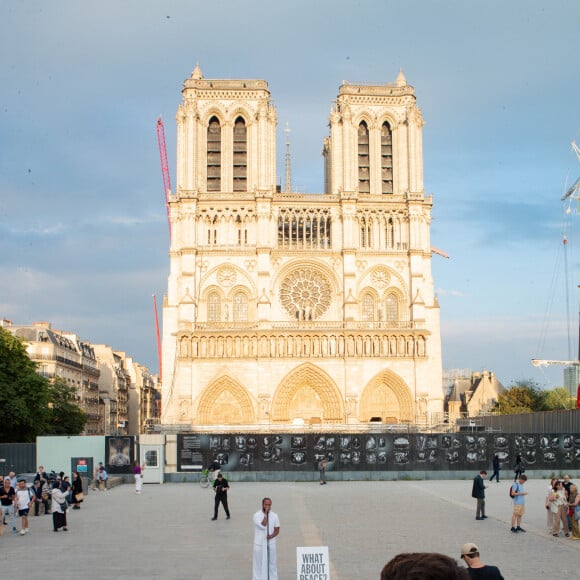 Exclusif - Slimane interprète sa nouvelle chanson "Résister" sur le parvis de Notre-Dame à Paris. Le 6 juin 2024. A quelques jours de la sortie de ce nouveau single, le chanteur a fait un happening étonnant hier soir à 20h30 entouré de 30 choristes. Ces images tournées intégreront le clip qui, lui aussi, sortira prochainement. © Christophe Clovis / Bestimage 