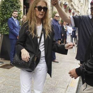 Paris, FRANCE - Canadian singer Celine Dion leaves her hotel for the airport, taking time to greet and sign autographs for the crowd of fans waiting for her, showing her appreciation for their support. Pictured: Celine Dion