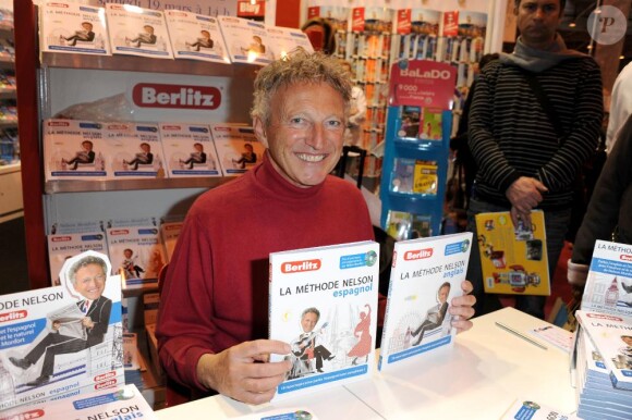 Nelson Monfort fait quelques dédicaces sur son livre Les deux méthodes Monfort lors du Salon du Livre au Parc des Expositions à Porte de Versailles à Paris, le 19 mars 2011