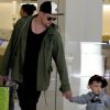 Joel Madden et son fils Sparrow, un an et demi, se rendent dans un Apple Store, à Los Angeles, le 16 mai 2011.