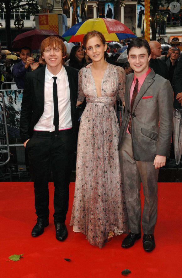 Daniel Radcliffe, Emma Watson et Rupert Grint sous la pluie en juillet 2009 lors de l'avant-première de Harry Potter et le prince de sang-mêlé