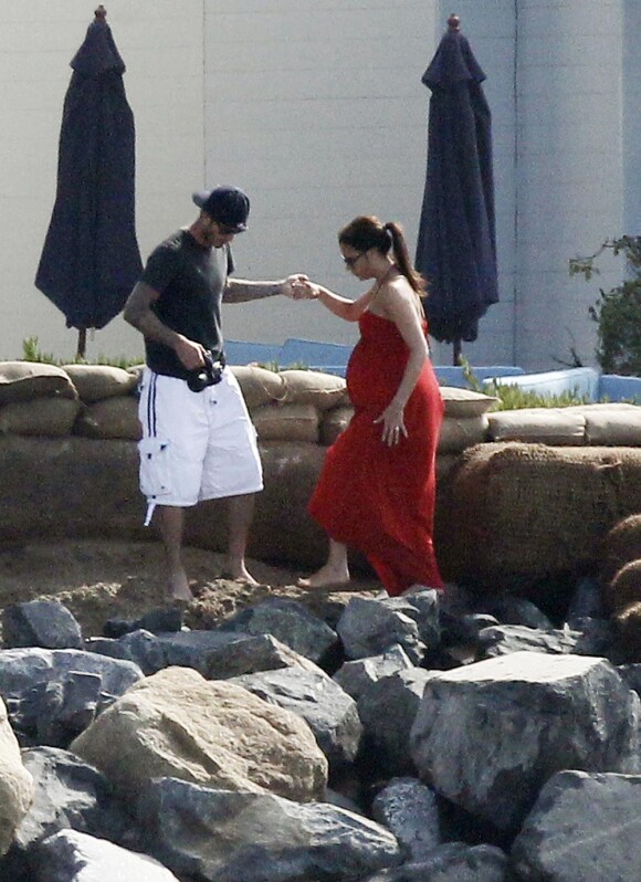 Victoria Beckham enceinte en juillet 2011, avec son mari David