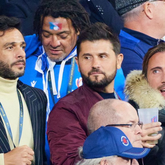 Maxim Nucci (Yodelice), Christophe Beaugrand et son mari Ghislain Gerin - People des les tribunes de la coupe du Monde de Rugby France 2023 - Match de quart de finale "France-Afrique du Sud (28-29)" au Stade de France à Saint-Denis 15 octobre 2023. © Moreau-Jacovides/Bestimage