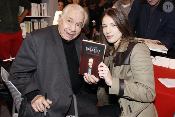 Michel Galabru et sa petite fille Sophie Galabru à la 33eme édition du Salon du Livre de la porte de Versailles a Paris le 24 mars 2013. CEDRIC PERRIN / BESTIMAGE