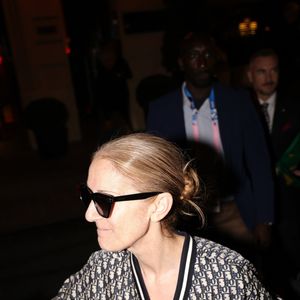 Paris, FRANCE  - Celine Dion in full Dior creates a crowd movement as she exits through the roof of her car leaving her hotel in Paris followed by her fans



Pictured: Celine Dion