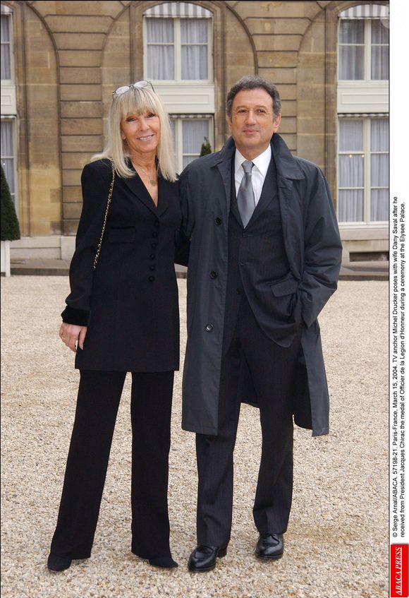 Le présentateur de télévision Michel Drucker pose avec son épouse Dany Saval après avoir reçu des mains du Président Jacques Chirac la médaille d'Officier de la Légion d'Honneur lors d'une cérémonie au Palais de l'Elysée le 15 mars 2004. © Serge Arnal/ABACA.