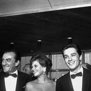 Luchino Visconti, Claudia Cardinale et Alain Delon à la fête sur l'Ausonia pour la présentation du film 'Rocco e i suoi fratelli', 21ème Festival du Film de Venise (1961). Photo by Alamy/ABACAPRESS.COM