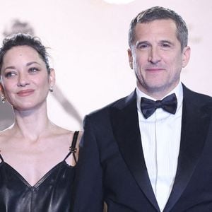 Marion Cotillard et Guillaume Canet quittent la projection de "Karma" sur le tapis rouge du 79ème Festival de Cannes au Palais des Festivals le 15 mai 2026 à Cannes, France. Photo by Jerome Domine/ABACAPRESS.COM