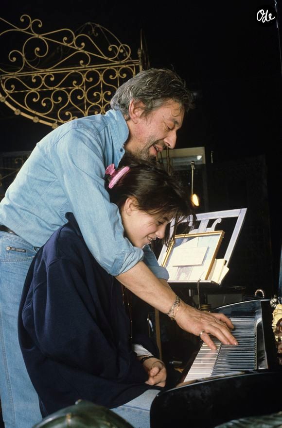 En France, à Paris, Serge Gainsbourg chez lui avec sa fille Charlotte dans son hotel particulier de la rue de Verneuil, posant au milieu de son bric-à-brac où il entasse des objets hétéroclites en mai 1985. © Michel Marizy via Bestimage