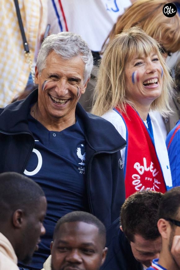 Mélanie Page et Nagui dans les tribunes du match du groupe D de l'Euro 2024 entre l'équipe de France face à l'Autriche (1-0) à Dusseldorf en Allemagne le 17 juin 2024. 

© Cyril Moreau/Bestimage