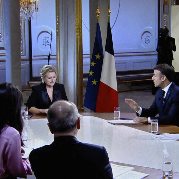 Le président français Emmanuel Macron avec Anne-Elisabeth Lemoine, Mohamed Bouhafsi, Patrick Cohen, Emilie Tran Nguyen et Pierre Lescure sur un écran de télévision à Paris lors d'une interview en direct diffusée dans l'émission '' C a vous '' de la chaîne de télévision française France 5, le 20 décembre 2023. Photo by Eliot Blondet/ABACAPRESS.COM