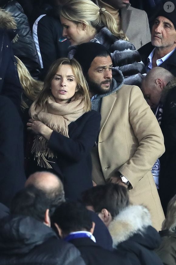 Maxim Nucci et sa compagne Isabelle Ithurburu enceinte assistent au huitième de finale retour de Ligue des Champion, du Paris Saint-Germain contre le Real Madrid au Parc des Princes à Paris le 6 mars 2018. © Cyril Moreau/Bestimage