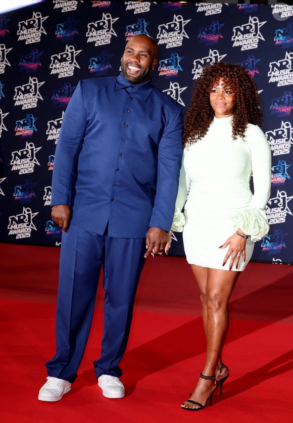 Teddy Riner et sa compagne Luthna Plocus au photocall de la 27ème édition des NRJ Music Awards au palais des Festivals de Cannes, France, le 31 octobre 2025. © Dominique Jacovides/Bestimage