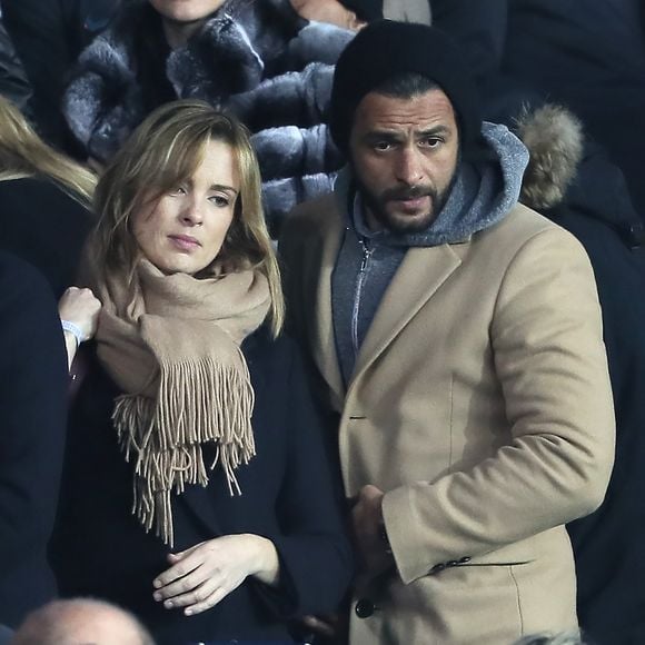 Maxim Nucci et sa compagne Isabelle Ithurburu enceinte assistent au huitième de finale retour de Ligue des Champion, du Paris Saint-Germain contre le Real Madrid au Parc des Princes à Paris le 6 mars 2018. © Cyril Moreau/Bestimage