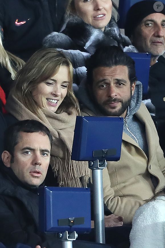 Maxim Nucci et sa compagne Isabelle Ithurburu enceinte assistent au huitième de finale retour de Ligue des Champion, du Paris Saint-Germain contre le Real Madrid au Parc des Princes à Paris le 6 mars 2018. © Cyril Moreau/Bestimage