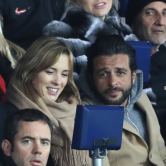 Maxim Nucci et sa compagne Isabelle Ithurburu enceinte assistent au huitième de finale retour de Ligue des Champion, du Paris Saint-Germain contre le Real Madrid au Parc des Princes à Paris le 6 mars 2018. © Cyril Moreau/Bestimage