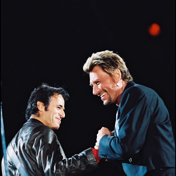 ARCHIVES - JEAN JACQUES GOLDMAN ET JOHNNY HALLYDAY SUR SCENE LORS D' UN CONCERT AU STADE DE FRANCE