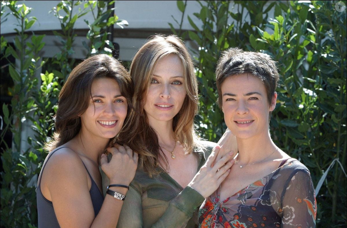 A glamorous French actress smiling subtly