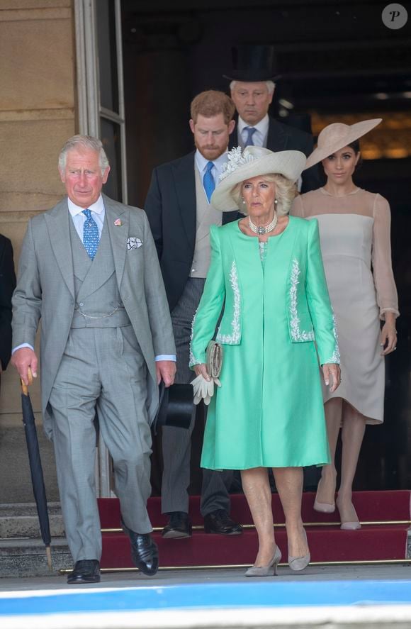 Camilla Parker Bowles, duchesse de Cornouailles, le prince Harry, duc de Sussex, et Meghan Markle, duchesse de Sussex, lors de la garden party pour les 70 ans du prince Charles au palais de Buckingham à Londres. Le 22 mai 2018