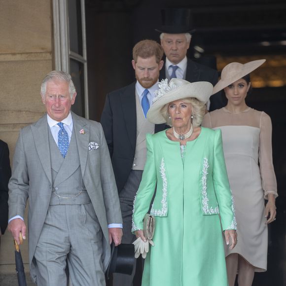 Camilla Parker Bowles, duchesse de Cornouailles, le prince Harry, duc de Sussex, et Meghan Markle, duchesse de Sussex, lors de la garden party pour les 70 ans du prince Charles au palais de Buckingham à Londres. Le 22 mai 2018