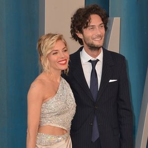 Sienna Miller officialise son couple avec son compagnon Oli Green, mannequin Burberry au photocall de la soirée "Vanity Fair" lors de la 94ème édition de la cérémonie des Oscars au Wallis Annenberg Center for the Performing Arts dans le quartier de Beverly Hills, à Los Angeles, Californie, Etats-Unis, le 27 mars 2022.