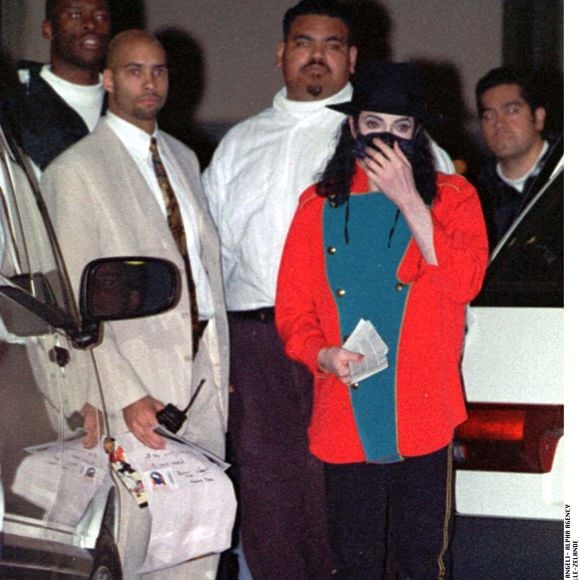 Novembre 1996, Auckland. Michael Jackson masqué, coiffé d’un chapeau, devant l’hôtel Carlton, entouré de ses gardes du corps. © Alpha Agency / Bestimage