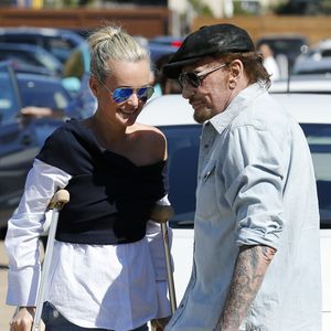 Johnny Hallyday avec sa femme Laeticia, qui marche toujours avec des béquilles, accompagnés de Maxim Nucci (Yodelice), arrivent au restaurant "Soho House" à Malibu, le 09 mars 2017. (Agence / Bestimage).
