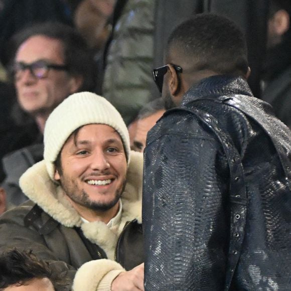 Vianney et Gims dans les tribunes du match de Ligue 1 McDonald's opposant le Paris Saint-Germain (PSG) à Lyon (3-1) au Parc des Princes à Paris le 15 décembre 2024.