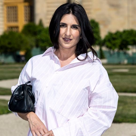Pour cette apparition, Géraldine Nakache portait une robe noire moulante qui mettait en valeur son ventre rond, même sous une chemise légère.

 Geraldine Nakache - VIP @ Défilé de mode Jacquemus dans les jardins de l'Orangerie à Versailles le 29 juin 2025. au photocall du défilé Jacquemus de la mode homme Printemps/Été 2026 dans le cadre de la Fashion Week de Paris dans les jardins de l'Orangerie à Versailles, France. © Olivier Borde/Bestimage