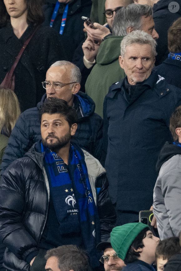 Christophe Beaugrand, Gilles Bouleau et Denis Brogniart - Célébrités dans les tribunes du quart de finale de la Ligue des Nations de l'UEFA 2025 "France - Croatie (2-0 / tab 5-4)" au Stade de France à Saint-Denis le 23 mars 2025. © Cyril Moreau/Bestimage