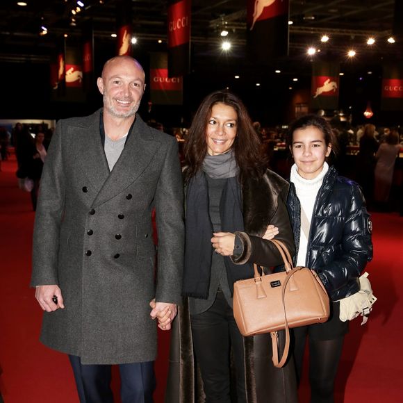 Frank Leboeuf avec sa compagne Chrislaure Nollet (ex-femme de Fabrice Santoro) et la fille de celle-ci Djenae - Gucci Paris Masters 2013 a Villepinte le 8 decembre 2013.
Crédit : JLPPA / Bestimage