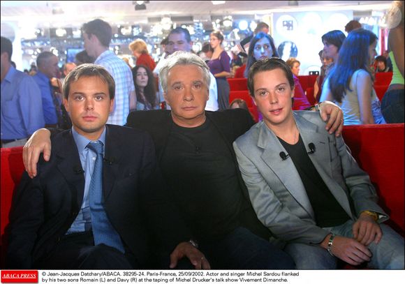 L'acteur et chanteur Michel Sardou entouré de ses deux fils Romain et Davy lors de l'enregistrement de l'émission Vivement Dimanche de Michel Drucker, à Paris, France, le 25 septembre 2002. Crédit Jean-Jacques Datchary/Abaca