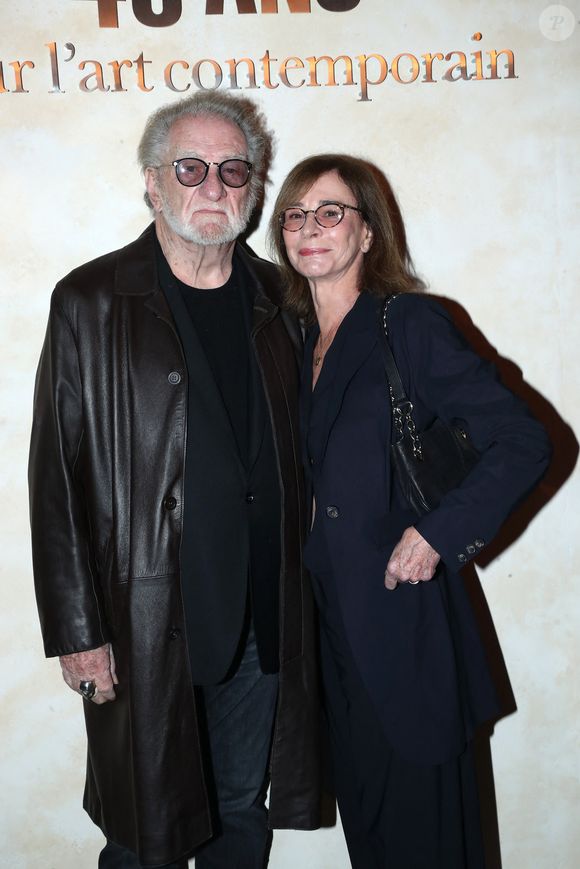 Eddy Mitchell et sa femme Muriel Bailleul - " Voir venir Venir voir ", Célébration des 40 ans de la Fondation Cartier pour l'art contemporain avec la " Traversée du chantier de la nouvelle Fondation Cartier ", place du Palais Royal, dont l'ouverture se fera en décembre 2025. Paris, France, le 18 octobre 2024. Bertrand Rindoff/Bestimage