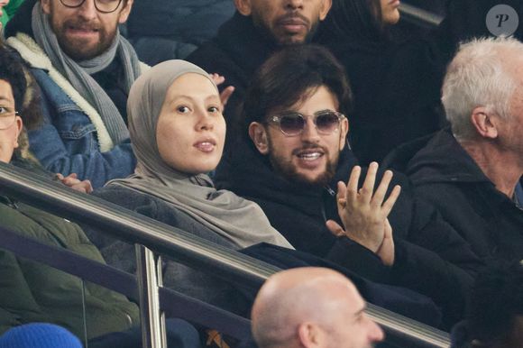 Just Riadh et sa femme dans les tribunes lors du match de Ligue Des Champions 2024-2025 (LDC) "PSG - Brest (7-0)" au Parc Des Princes, le 19 février 2025.
© Cyril Moreau/Bestimage